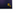 Close up of the Triptych company logo, in gold foil on a dark blue background. Logo features two interlocking squares.