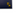 Close up of the Triptych company logo, in gold foil on a dark blue background. Logo features two interlocking squares.